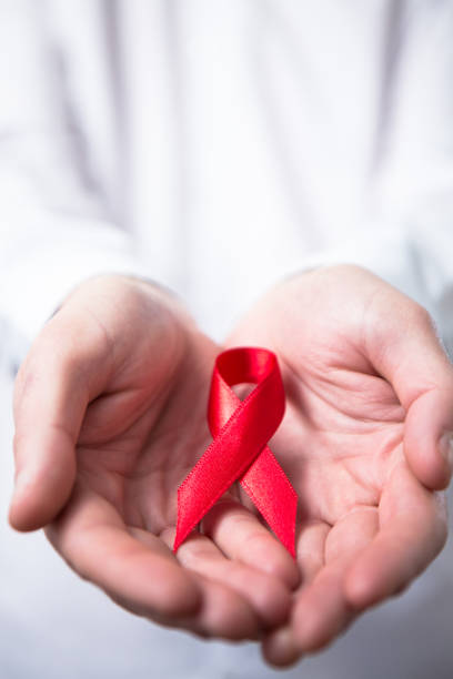 istock Man holding red aids ribbon 845453006