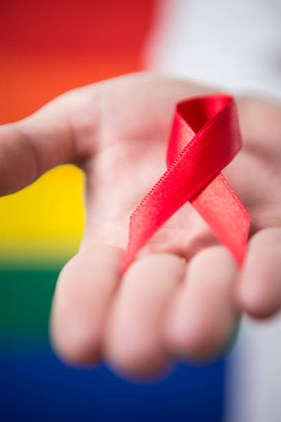 istock Man holding red aids awareness ribbon 845455038