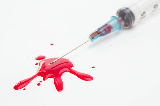 istock Syringe and a pool of blood 845461078