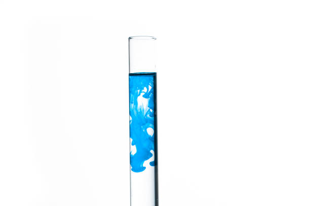 Test tube of water with blue paint on white background