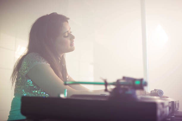 istock Pretty female DJ playing music 845464720
