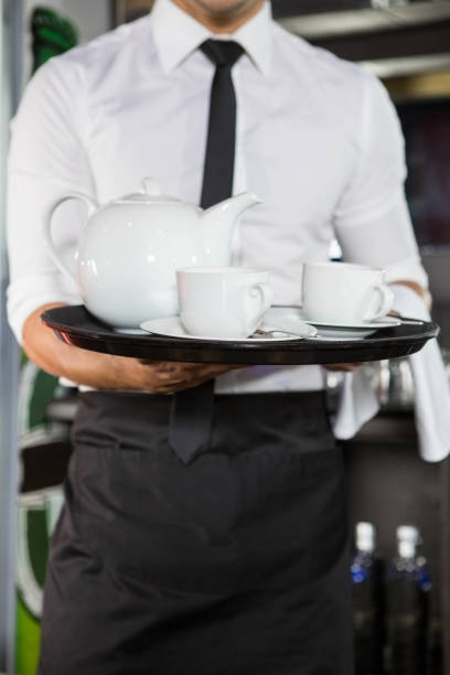 istock Mid section of waiter serving tea 845464828
