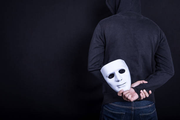 istock Mystery man holding white mask in the back 845467672