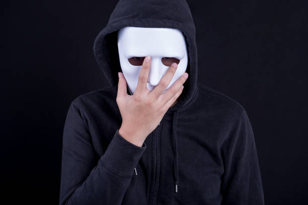 istock Mystery man holding white mask for hide his face 845470616