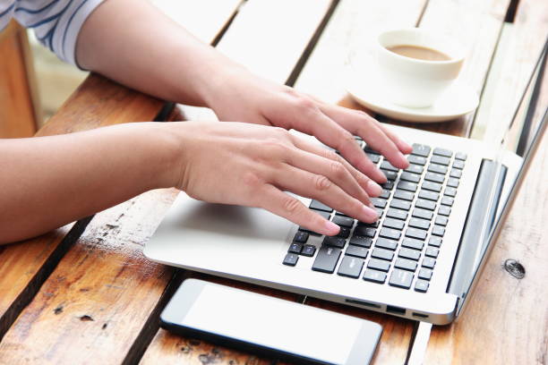 istock Female hand typing with laptop 845470696