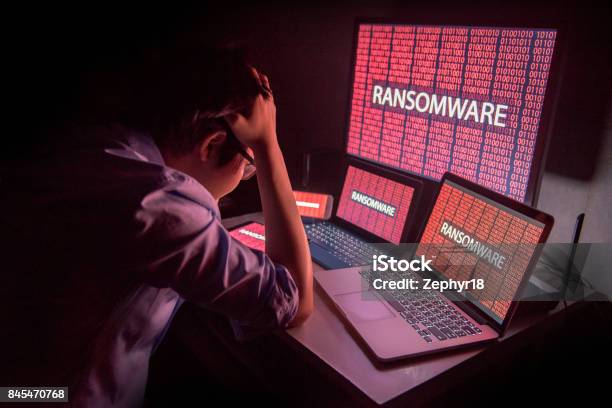 Young Asian Male Frustrated By Ransomware Cyber Attack Stock Photo - Download Image Now