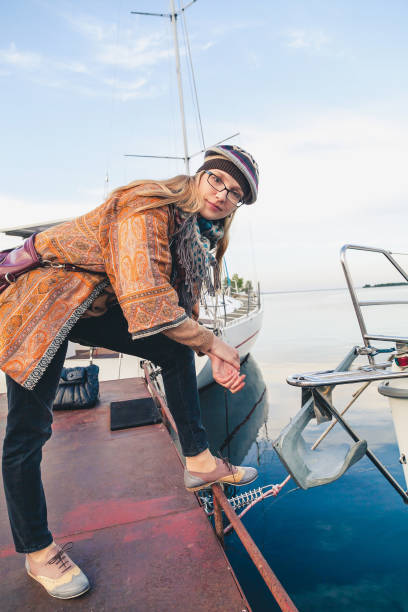 istock Young girl in a beret standing on the dock 845471282
