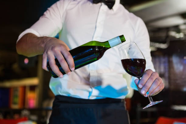 istock Waiter pouring wine in a glass 845474162