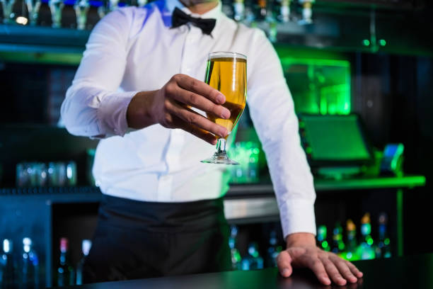 istock Bartender serving a glass of beer 845474240