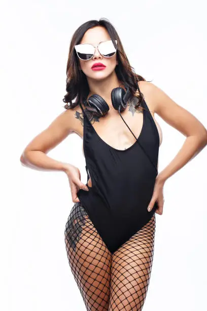 sexy girl DJ in top and pantyhose on a white background
