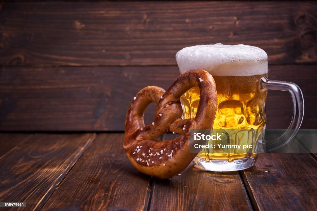 Beer Fest food on wooden background Mug of beer and pretzel for Beer Fest on wooden background. Copy space. Pretzel Stock Photo