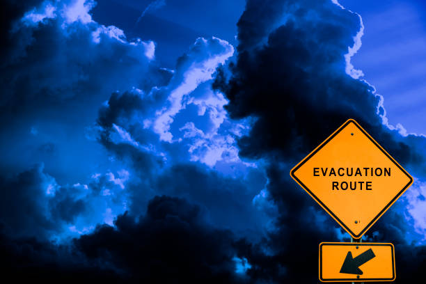 Evacuation Route Road Sign Evacuation route road sign in front of dramatic sky georgia tornado stock pictures, royalty-free photos & images