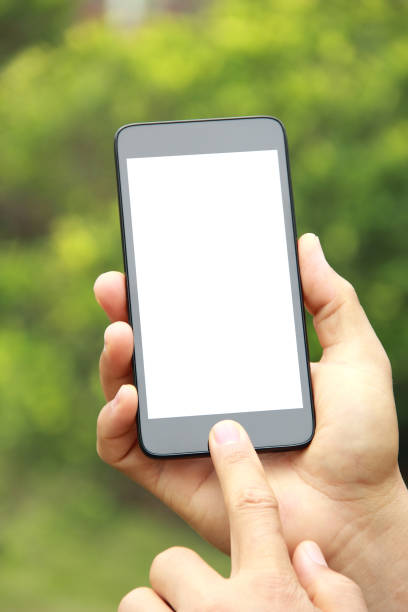 istock Male hand holding blank mobile phone outdoors 845483330