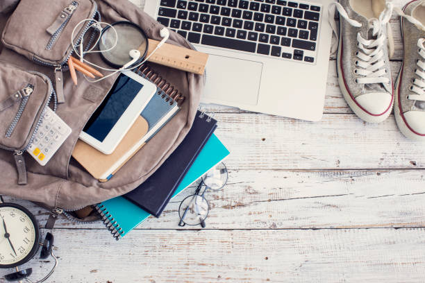 backpack with school supplies - above laptop desk computer imagens e fotografias de stock