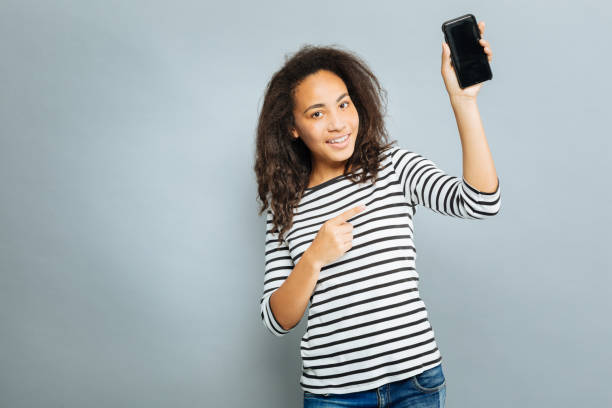 istock Modern girl pointing at her phone 845490148