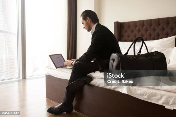 Entrepreneur Checks Presentation In Hotel Room Stock Photo - Download Image Now - Apartment, Internet, Making a Reservation