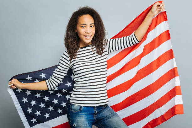 istock Patriotic female demonstrating big American flag 845490466
