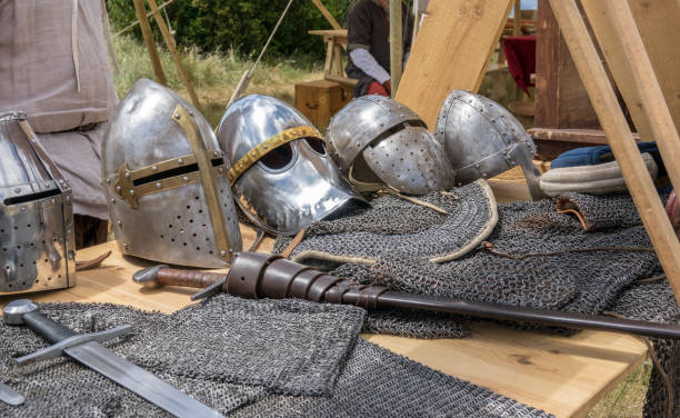 istock Detail of several medieval helmets helms, chainmail and shields a medieval armor knight 845494750