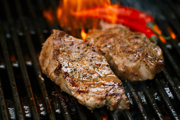 istock pork steak on bbq grill with flame 845507858