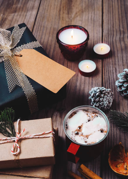 istock Christmas present gift boxes and rustic decoration with candle, hot chocolate 845508944