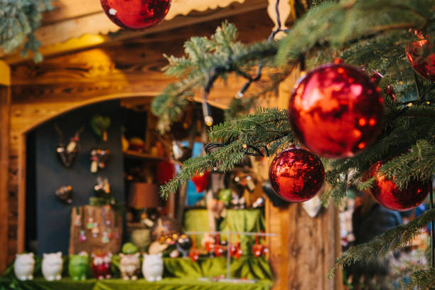 istock Christmas decorations on a Christmas tree in the form of red balls. In the background is the Christmas market. Concept of the holiday. 845512708