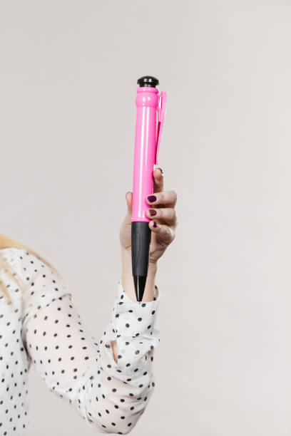 istock Woman holding big oversized pen 845516110