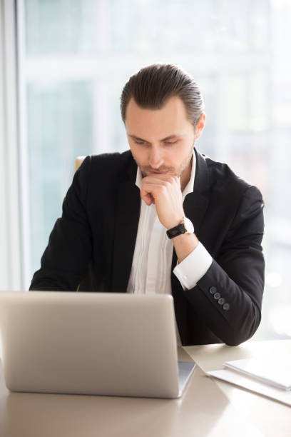 istock Serious thoughtful businessman working on laptop in office. 845516162