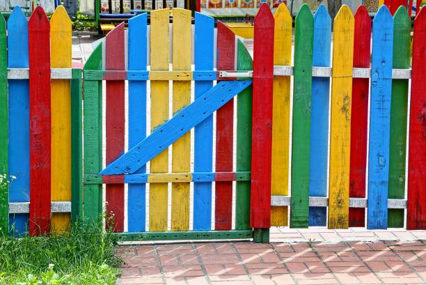 istock part of a colored fence with a closed gate 845517110