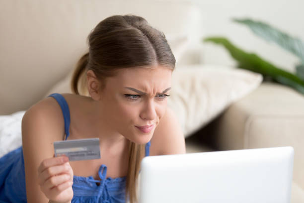 förvirrad kvinna har problem med kreditkort betalning online - kvinna telefonbedragare bildbanksfoton och bilder
