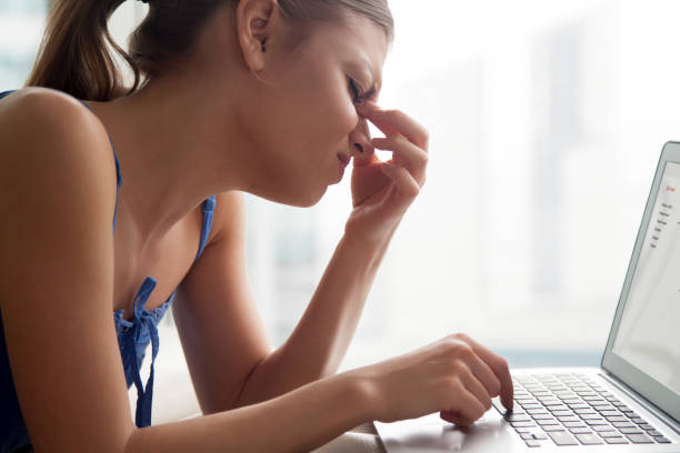 istock Young woman feeling tired, massaging nose bridge, suffering from headache 845526994