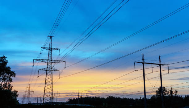 istock power transmission tower silhouetted against the sunset glow. 845530164