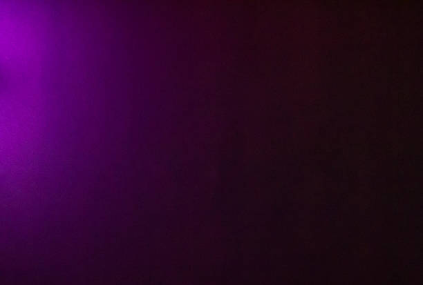 istock Purple neon lights casting color on a concrete wall. 845538950