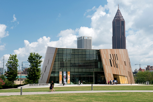 Atlanta, USA - August 12, 2017. People walking past or gathering at the entrance of the Center for Civil and Human Rights, which is located in downtown Atlanta, a short distance from Centennial Olympic Park. It is a museum for the history of human rights movement in the United States and connection to the world wide human rights movement.