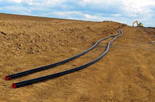 istock Construction site in rural area with heavy machinery in work with barrier/signal in foreground. 845549744