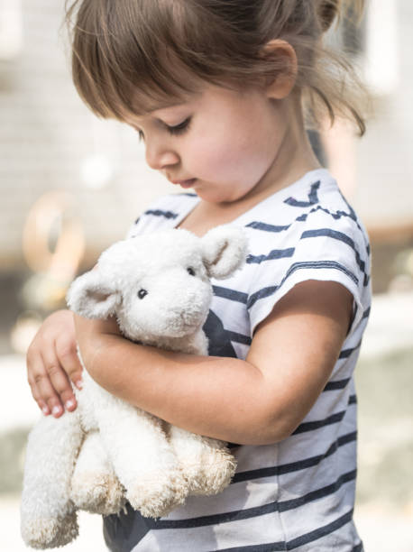 istock little girl with toy lamb 845552954