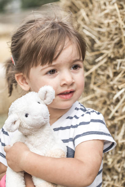 istock little girl with toy lamb 845552956