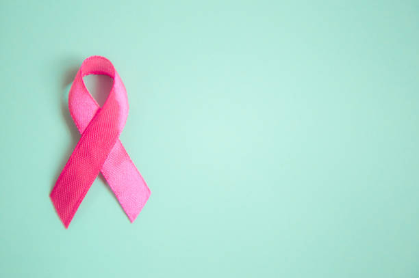 pink ribbon breast cancer on a blue background. top view  top. Place for text pink ribbon breast cancer on a blue background. pink ribbon breast cancer on a pink background. top view  top. Place for text. metastasis photos stock pictures, royalty-free photos & images
