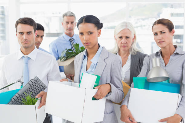 istock Unhappy fired business people holding box 845560104