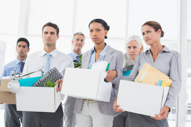 istock Unhappy fired business people holding box 845560120