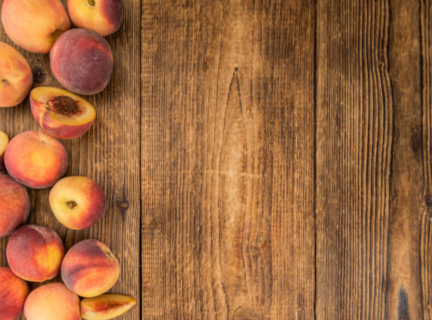 istock Portion of Fresh Peaches on wooden background, selective focus 845563606