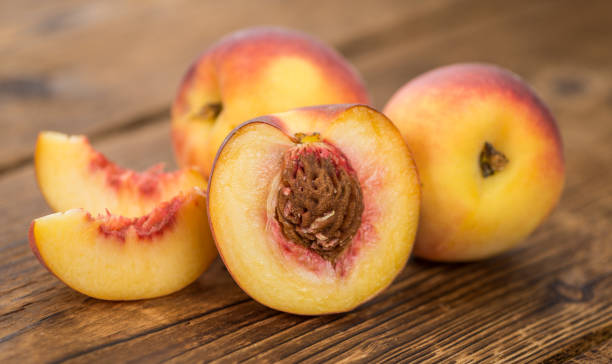 istock Portion of Fresh Peaches on wooden background, selective focus 845563710