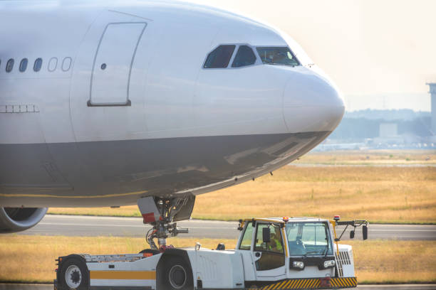 istock an airplane beeing towed with a modern towing vehicle 845569712