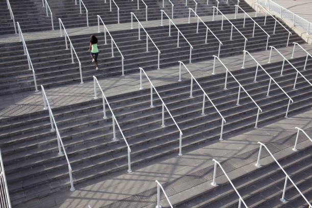 istock Woman practicing, running on stadium stairs. 845576596