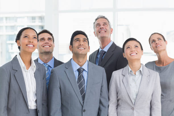 istock Business people looking up in office 845576852