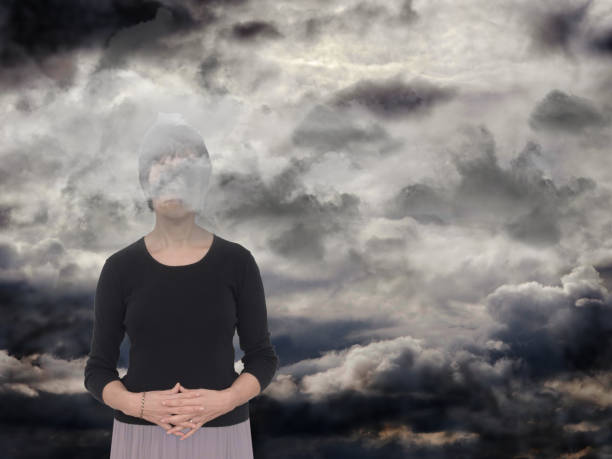 Woman with grey clouds. Depression,sadness concept. With copy space. seasonal affective disorder stock pictures, royalty-free photos & images