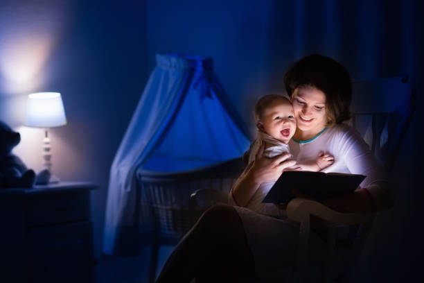 istock Mother reading a book to little baby 845583020