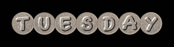 istock TUESDAY – Coins on black background 845589564