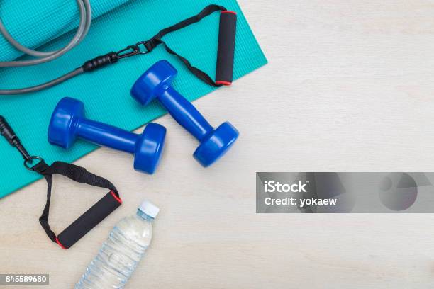 Dumbbells Exercise Equipment Gym Yoga Mat And Bottle Of Water On Clean Wood Floor Healthy And Well Being Concept With Room For Text Or Copy Space Stock Photo - Download Image Now