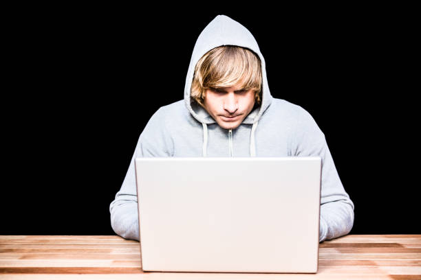 istock Man in hood jacket hacking a laptop 845592326