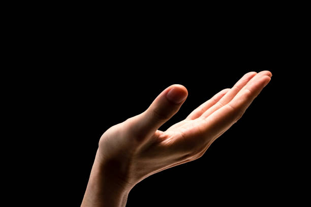 istock Male hand on a black background. 845593210